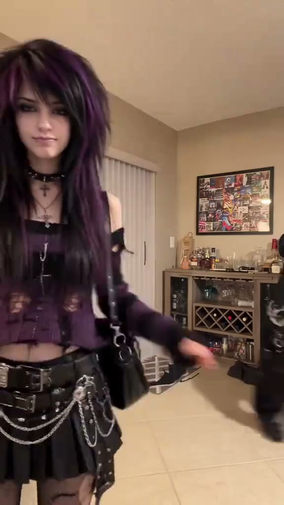 Two friends in dark emo outfits repeat the point, hops and swap indoors.