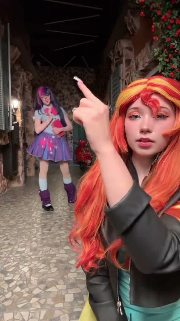 My Little Pony cosplayers take turns hopping outdoors at night.